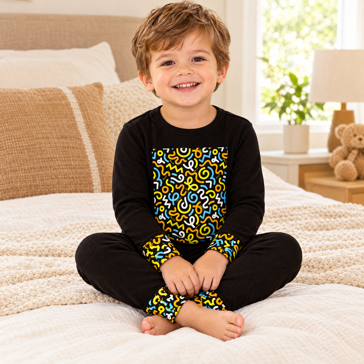 Toddler boy wearing Dottie Lou Brush Pop black squiggle-print 2-piece pajama set