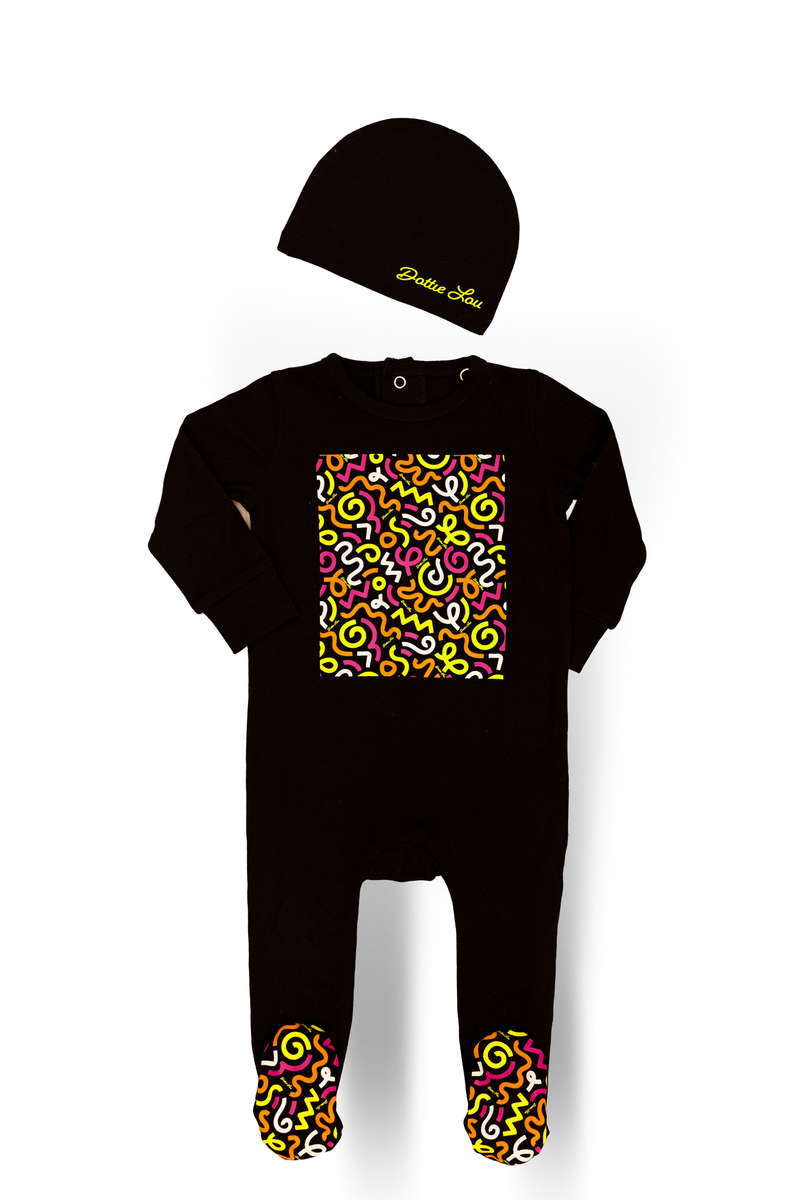 Dottie Lou Brush Pop baby footie pajama with matching hat in black with colourful squiggle doodle print - flatlay product photo