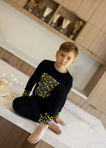 Kids in matching Dottie Lou Brush Pop black pajamas with colorful doodle print — family photo 8