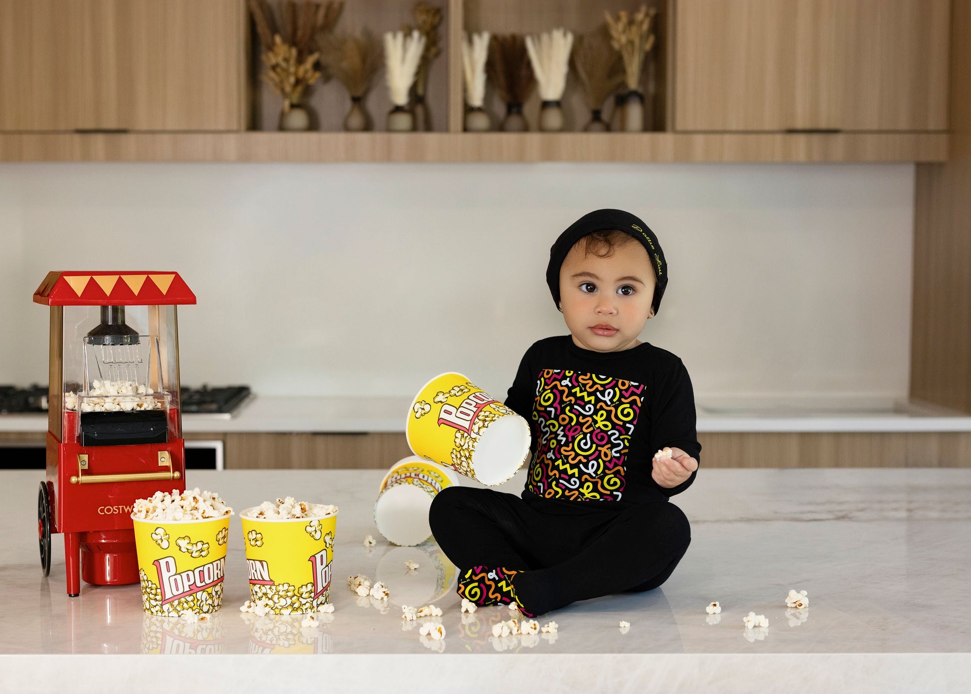 Child in Dottie Lou Brush Pop black pajamas with colorful doodle print — solo child model photo 4