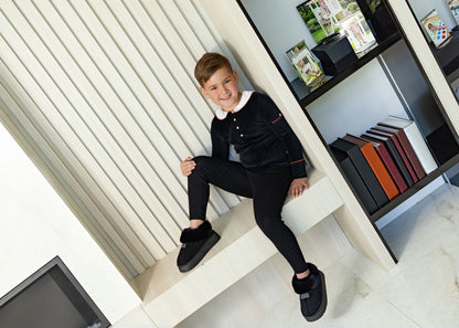 Kids wearing matching Dottie Lou Classic Noir black velour loungewear with ivory Peter Pan collars and orange piping — family photo 3