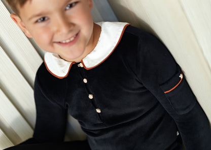 Kids wearing matching Dottie Lou Classic Noir black velour loungewear with ivory Peter Pan collars and orange piping — family photo 4
