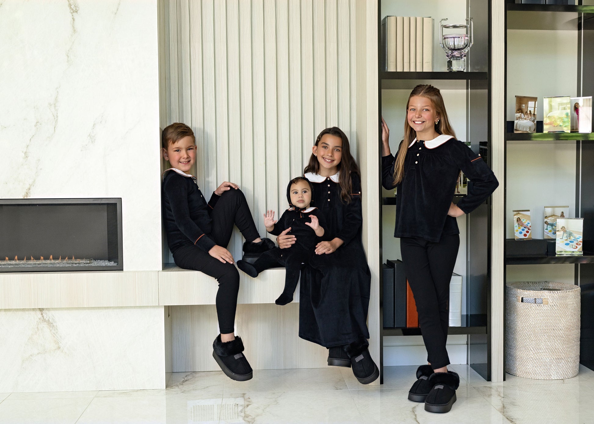 Kids wearing matching Dottie Lou Classic Noir black velour loungewear with ivory Peter Pan collars and orange piping — family photo 8