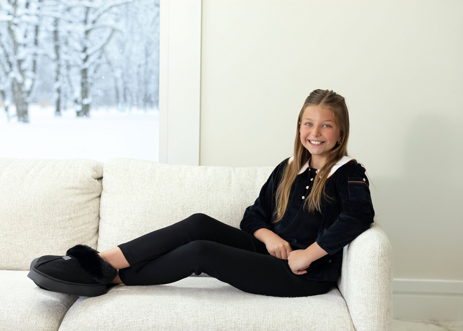 Kids wearing matching Dottie Lou Classic Noir black velour loungewear with ivory Peter Pan collars and orange piping — family photo 11