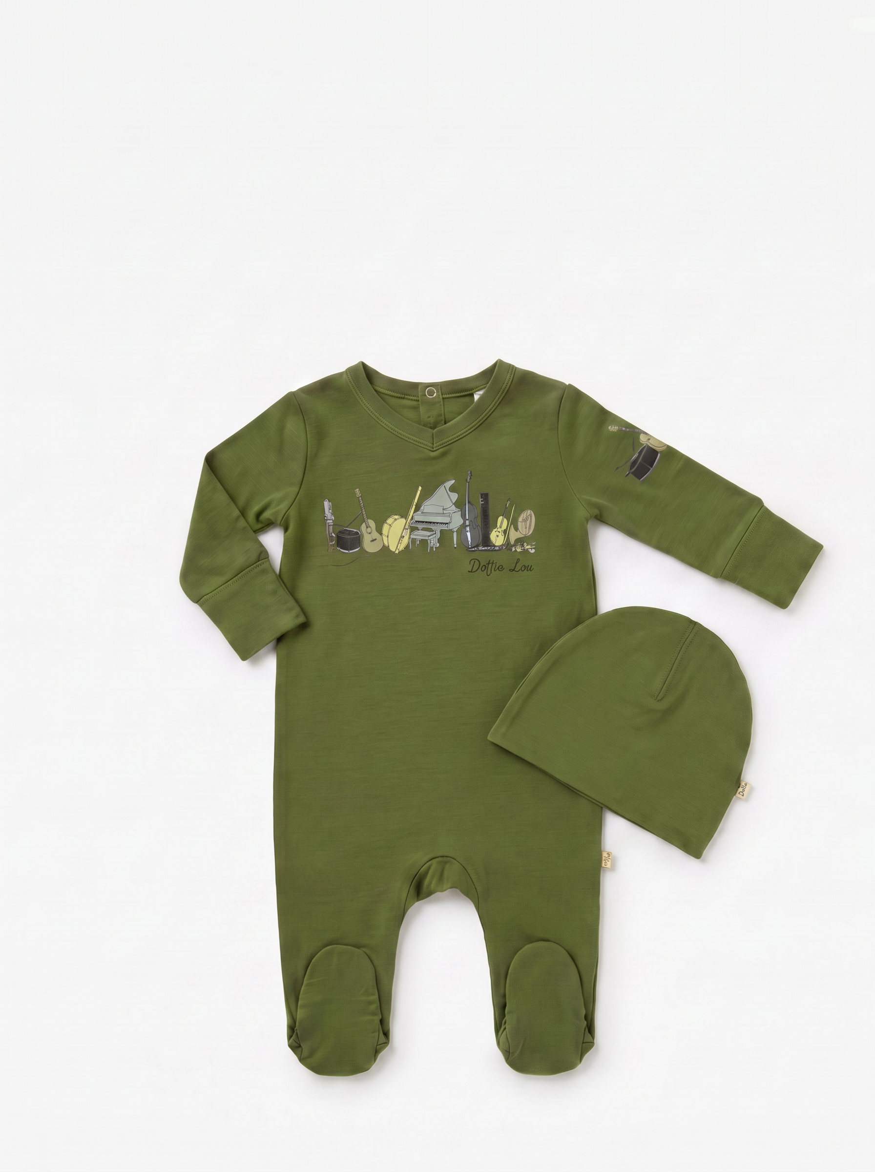 Dottie Lou Melody boys baby footie pajama with matching hat in moss green with hand-illustrated musical instrument music print — flatlay