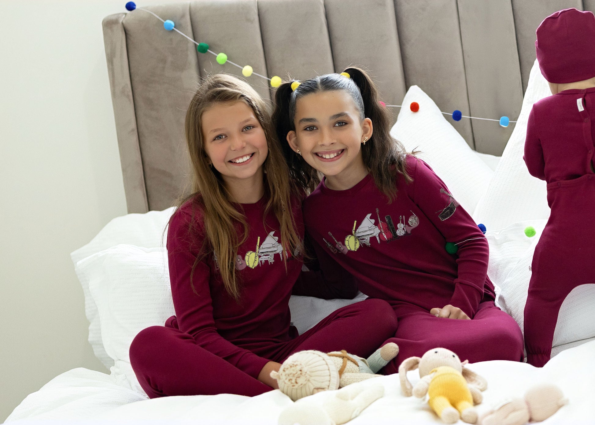 Kids in matching Dottie Lou Melody berry and moss green pajamas with music print — family photo 1