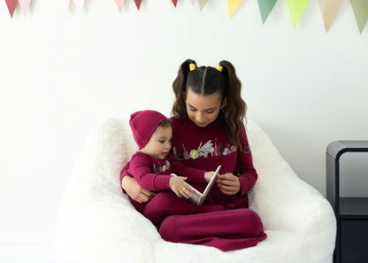 Kids in matching Dottie Lou Melody berry and moss green pajamas with music print — family photo 12